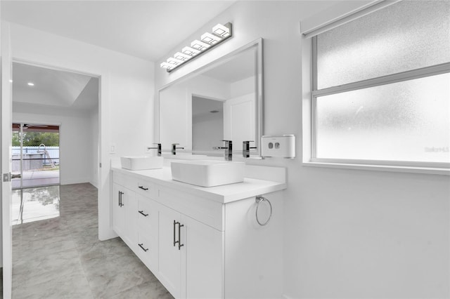 3010 52nd St W, Lehigh Acres, FL 33971 - bathroom with double vanity and baseboards