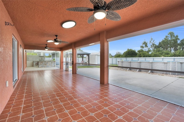 3010 52nd St W, Lehigh Acres, FL 33971 - fenced backyard with ceiling fan, a patio, and exterior kitchen