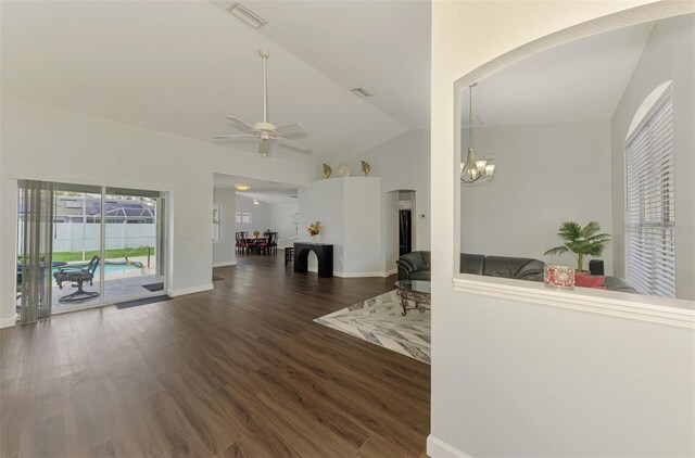 4038 Corydon Ave, North Port, FL 34286 - living room with vaulted ceiling, arched walkways, a chandelier, wood finished floors, and a ceiling fan