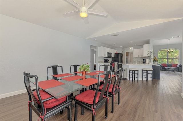 4038 Corydon Ave, North Port, FL 34286 - dining space with a ceiling fan, vaulted ceiling, and light wood-type flooring