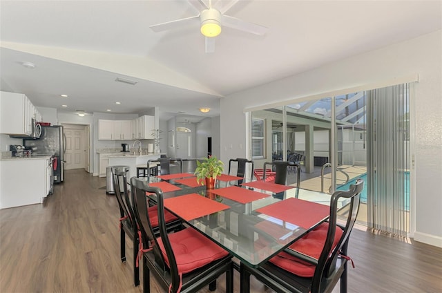 4038 Corydon Ave, North Port, FL 34286 - dining room with dark wood-type flooring, vaulted ceiling, and a ceiling fan
