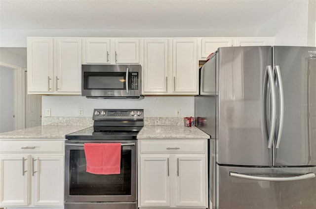 4038 Corydon Ave, North Port, FL 34286 - kitchen featuring appliances with stainless steel finishes, white cabinetry, and light stone counters