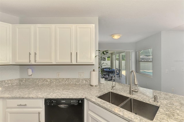4038 Corydon Ave, North Port, FL 34286 - kitchen with dishwashing machine, light stone countertops, and white cabinetry