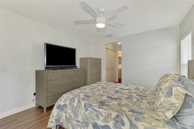4038 Corydon Ave, North Port, FL 34286 - bedroom featuring wood finished floors, arched walkways, and a ceiling fan