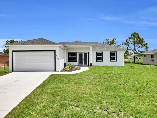 3202 41st St W, Lehigh Acres, FL 33971 - view of front of property featuring stucco siding, a garage, french doors, a front lawn, and driveway