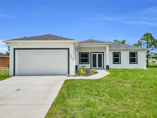3202 41st St W, Lehigh Acres, FL 33971 - view of front facade featuring french doors, stucco siding, an attached garage, driveway, and a front yard