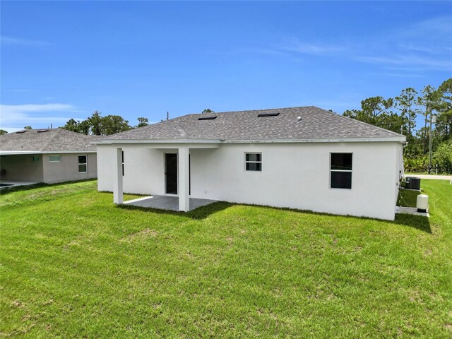 3202 41st St W, Lehigh Acres, FL 33971 - back of house with a patio, a lawn, stucco siding, and a shingled roof