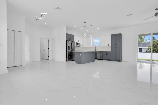 3202 41st St W, Lehigh Acres, FL 33971 - unfurnished living room with recessed lighting, light marble finish floors, a chandelier, and a high ceiling