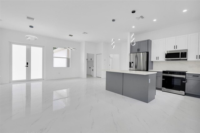 3202 41st St W, Lehigh Acres, FL 33971 - kitchen with stainless steel appliances, a kitchen island, gray cabinetry, light marble finish floors, and recessed lighting