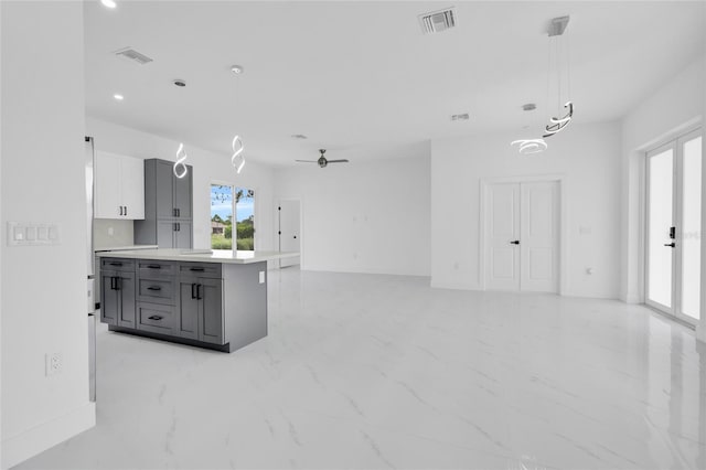 3202 41st St W, Lehigh Acres, FL 33971 - kitchen featuring gray cabinetry, light countertops, light marble finish flooring, a ceiling fan, and hanging light fixtures