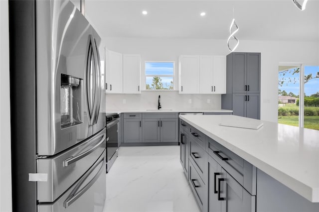 3202 41st St W, Lehigh Acres, FL 33971 - kitchen featuring stainless steel fridge with ice dispenser, stove, gray cabinets, light marble finish flooring, and plenty of natural light