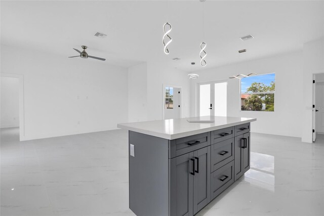 3202 41st St W, Lehigh Acres, FL 33971 - kitchen with gray cabinets, light countertops, a kitchen island, hanging light fixtures, and ceiling fan