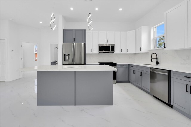3202 41st St W, Lehigh Acres, FL 33971 - kitchen with appliances with stainless steel finishes, gray cabinets, tasteful backsplash, recessed lighting, and a center island
