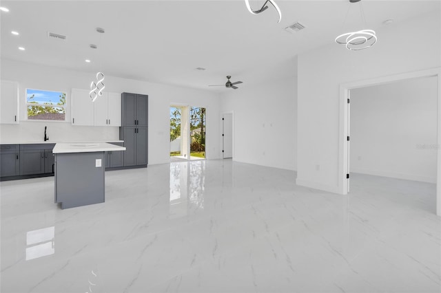 3202 41st St W, Lehigh Acres, FL 33971 - unfurnished living room featuring ceiling fan, light marble finish flooring, and recessed lighting