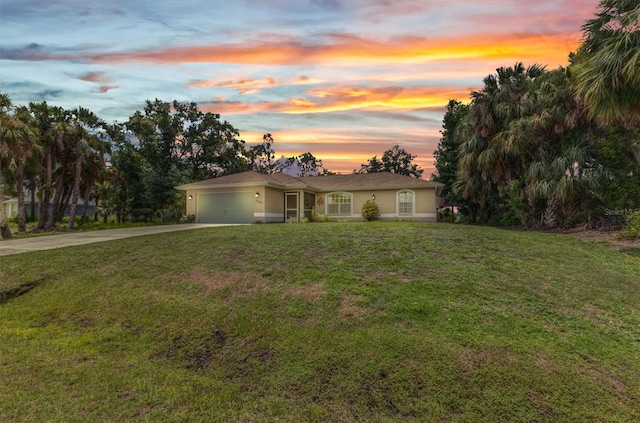 3305 Nansen Ln, North Port, FL 34286 - view of front of property featuring driveway, an attached garage, a yard, and stucco siding