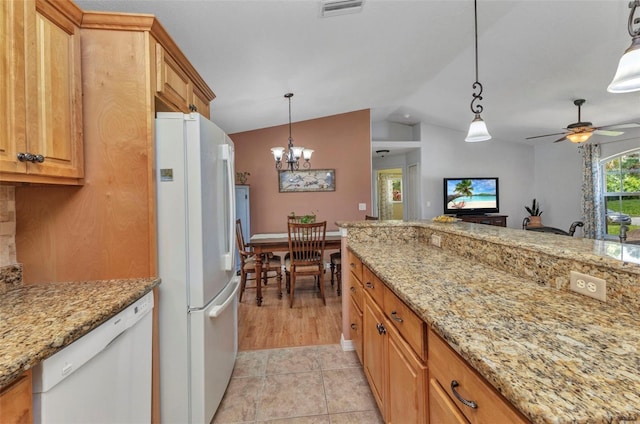 3305 Nansen Ln, North Port, FL 34286 - kitchen featuring white appliances, vaulted ceiling, a chandelier, hanging light fixtures, and light stone countertops