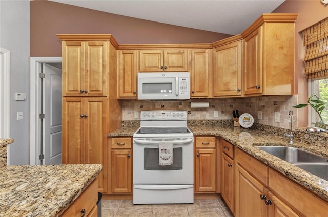 3305 Nansen Ln, North Port, FL 34286 - kitchen with white appliances, vaulted ceiling, decorative backsplash, and light stone counters