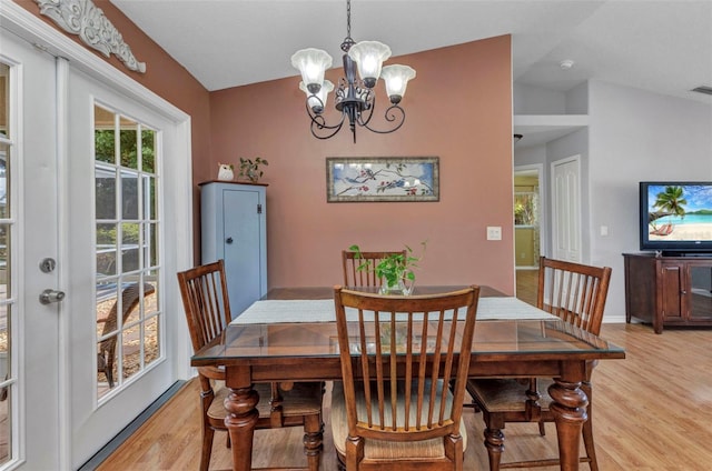3305 Nansen Ln, North Port, FL 34286 - dining room with light wood finished floors, lofted ceiling, and a chandelier