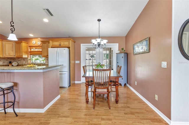 3305 Nansen Ln, North Port, FL 34286 - dining room featuring light wood-style floors, a chandelier, healthy amount of natural light, and recessed lighting
