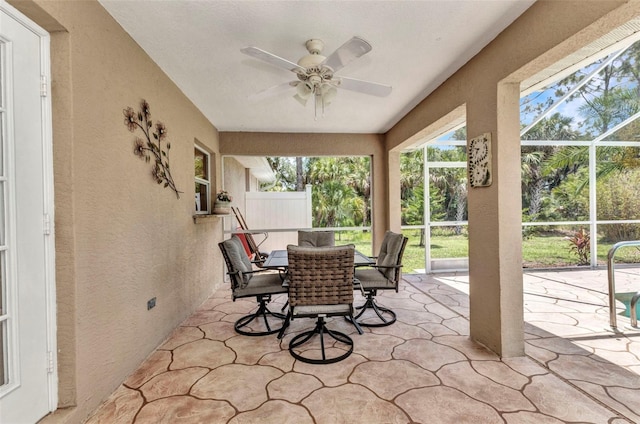 3305 Nansen Ln, North Port, FL 34286 - sunroom / solarium featuring a textured wall, a ceiling fan, and stone flooring