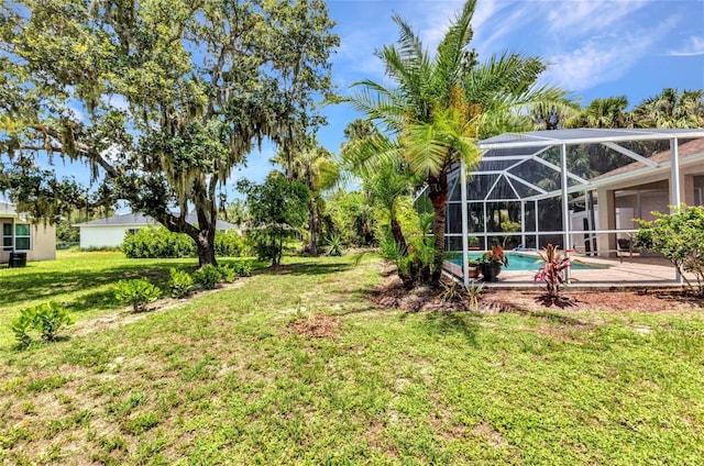 3305 Nansen Ln, North Port, FL 34286 - view of green lawn with an outdoor pool, a lanai, and a patio