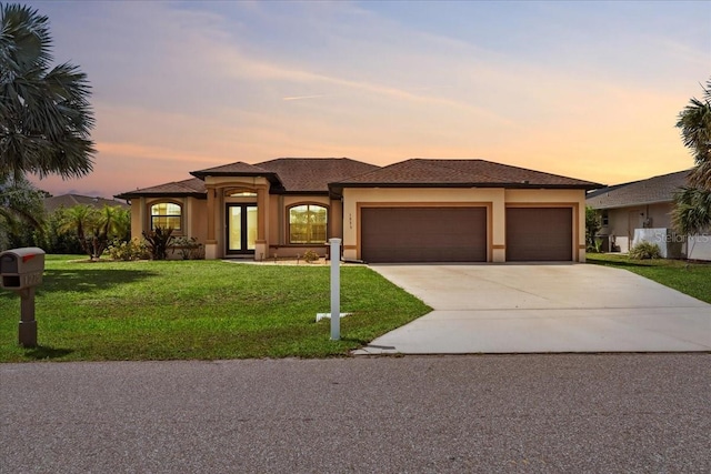 1275 Blue Lake Cir, Punta Gorda, FL 33983 - view of front facade with a garage, concrete driveway, a front lawn, and stucco siding