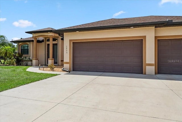 1275 Blue Lake Cir, Punta Gorda, FL 33983 - prairie-style house featuring concrete driveway, stucco siding, a garage, and a front lawn