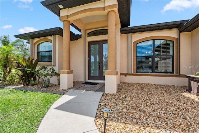 1275 Blue Lake Cir, Punta Gorda, FL 33983 - view of exterior entry with stucco siding and french doors