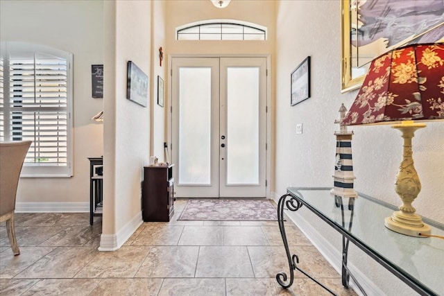 1275 Blue Lake Cir, Punta Gorda, FL 33983 - entrance foyer with french doors, a towering ceiling, and a textured wall