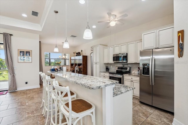 1275 Blue Lake Cir, Punta Gorda, FL 33983 - kitchen featuring appliances with stainless steel finishes, ceiling fan, decorative backsplash, ornamental molding, and light stone countertops