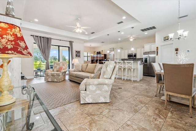 1275 Blue Lake Cir, Punta Gorda, FL 33983 - living area with a ceiling fan, a tray ceiling, a chandelier, and recessed lighting