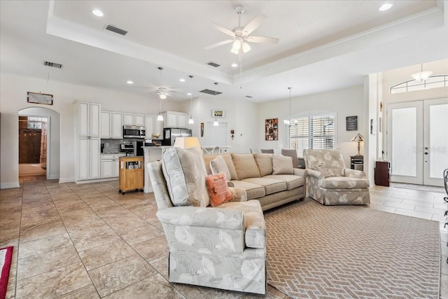 1275 Blue Lake Cir, Punta Gorda, FL 33983 - living room featuring a ceiling fan, a tray ceiling, arched walkways, recessed lighting, and french doors