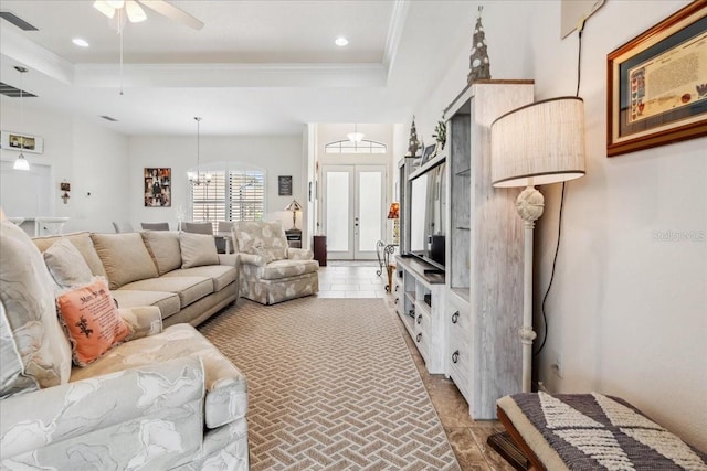 1275 Blue Lake Cir, Punta Gorda, FL 33983 - living room featuring a tray ceiling, ornamental molding, a ceiling fan, a chandelier, and recessed lighting