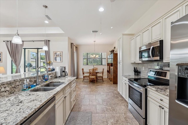 1275 Blue Lake Cir, Punta Gorda, FL 33983 - kitchen with stainless steel appliances, healthy amount of natural light, tasteful backsplash, stone tile flooring, and recessed lighting