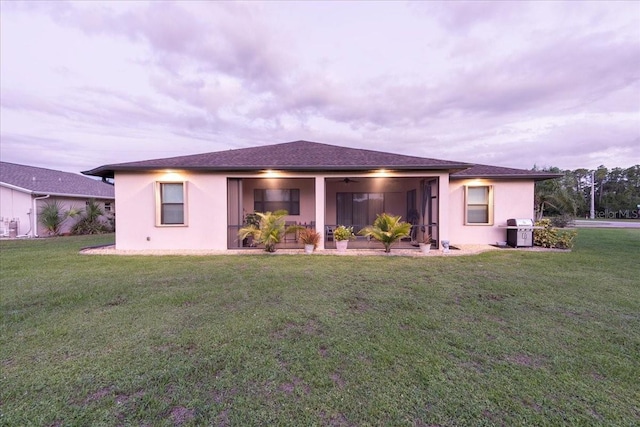 1275 Blue Lake Cir, Punta Gorda, FL 33983 - view of front facade featuring stucco siding, a ceiling fan, and a front yard