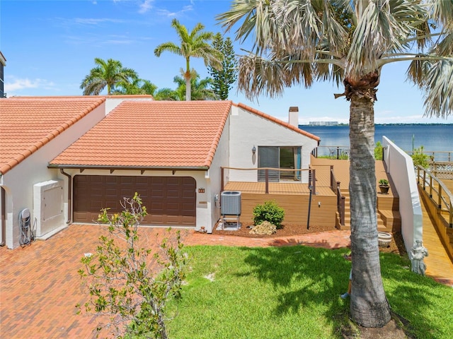 25188 Marion Ave Unit 45, Punta Gorda, FL 33950 - mediterranean / spanish house with stucco siding, a tiled roof, an attached garage, and a water view