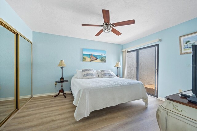 25188 Marion Ave Unit 45, Punta Gorda, FL 33950 - bedroom featuring access to outside, light wood-style floors, a ceiling fan, a closet, and a textured ceiling