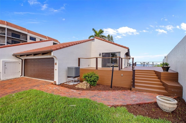 25188 Marion Ave Unit 45, Punta Gorda, FL 33950 - view of home's exterior with an attached garage, stucco siding, driveway, and a tile roof