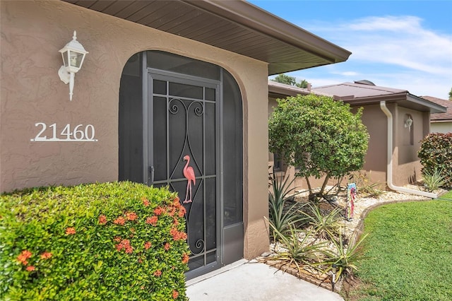 21460 Sheldon Ave, Port Charlotte, FL 33952 - view of exterior entry featuring stucco siding