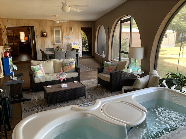 21460 Sheldon Ave, Port Charlotte, FL 33952 - living area with healthy amount of natural light, a ceiling fan, wooden walls, and carpet floors