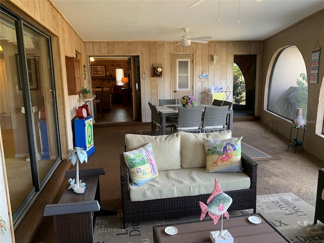 21460 Sheldon Ave, Port Charlotte, FL 33952 - carpeted living area with wood walls and ceiling fan