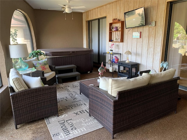 21460 Sheldon Ave, Port Charlotte, FL 33952 - living area featuring ceiling fan, wooden walls, carpet floors, and a wood stove
