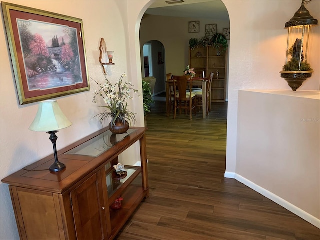 21460 Sheldon Ave, Port Charlotte, FL 33952 - hall with arched walkways and dark wood finished floors