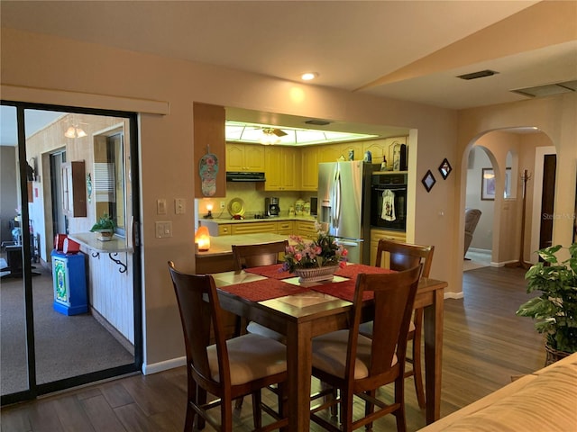21460 Sheldon Ave, Port Charlotte, FL 33952 - dining room featuring dark wood finished floors, arched walkways, and recessed lighting