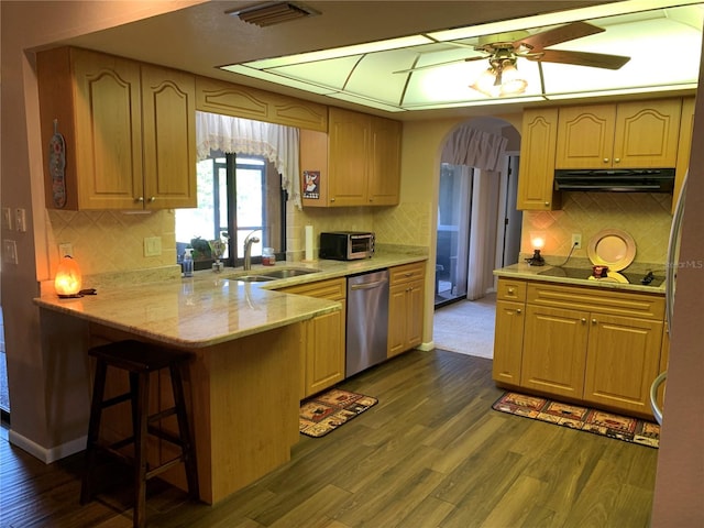21460 Sheldon Ave, Port Charlotte, FL 33952 - kitchen with stainless steel dishwasher, exhaust hood, black electric stovetop, a peninsula, and dark wood finished floors