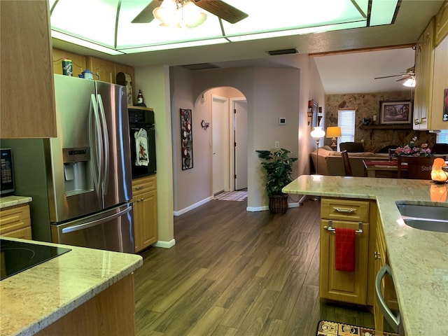 21460 Sheldon Ave, Port Charlotte, FL 33952 - kitchen featuring black appliances, ceiling fan, arched walkways, and wood finished floors