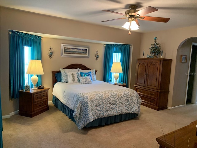 21460 Sheldon Ave, Port Charlotte, FL 33952 - bedroom with arched walkways, light carpet, and ceiling fan
