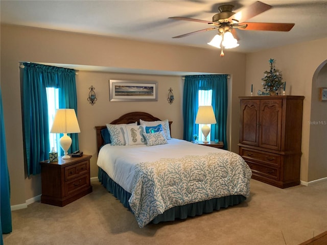 21460 Sheldon Ave, Port Charlotte, FL 33952 - bedroom with light carpet, arched walkways, and ceiling fan