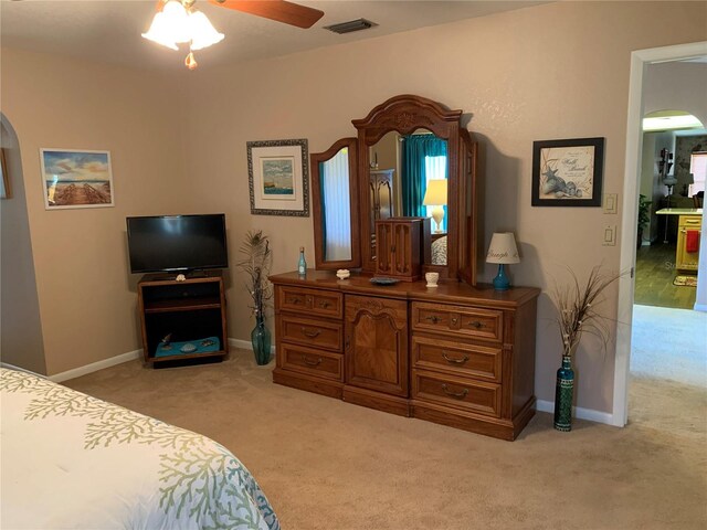21460 Sheldon Ave, Port Charlotte, FL 33952 - bedroom featuring arched walkways, light carpet, and a ceiling fan