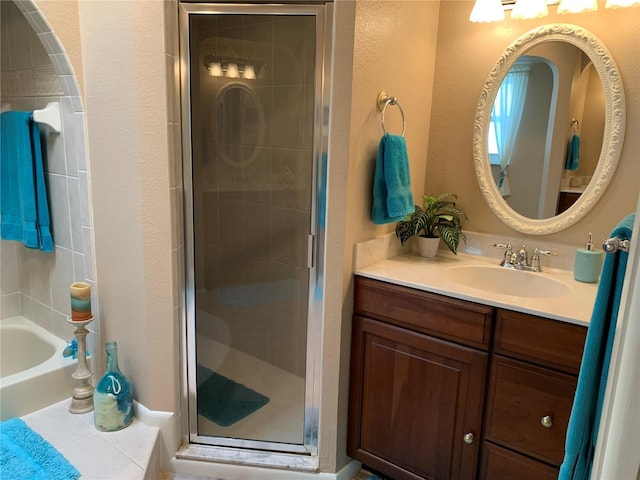 21460 Sheldon Ave, Port Charlotte, FL 33952 - full bathroom featuring vanity, a stall shower, a bathtub, and a textured wall